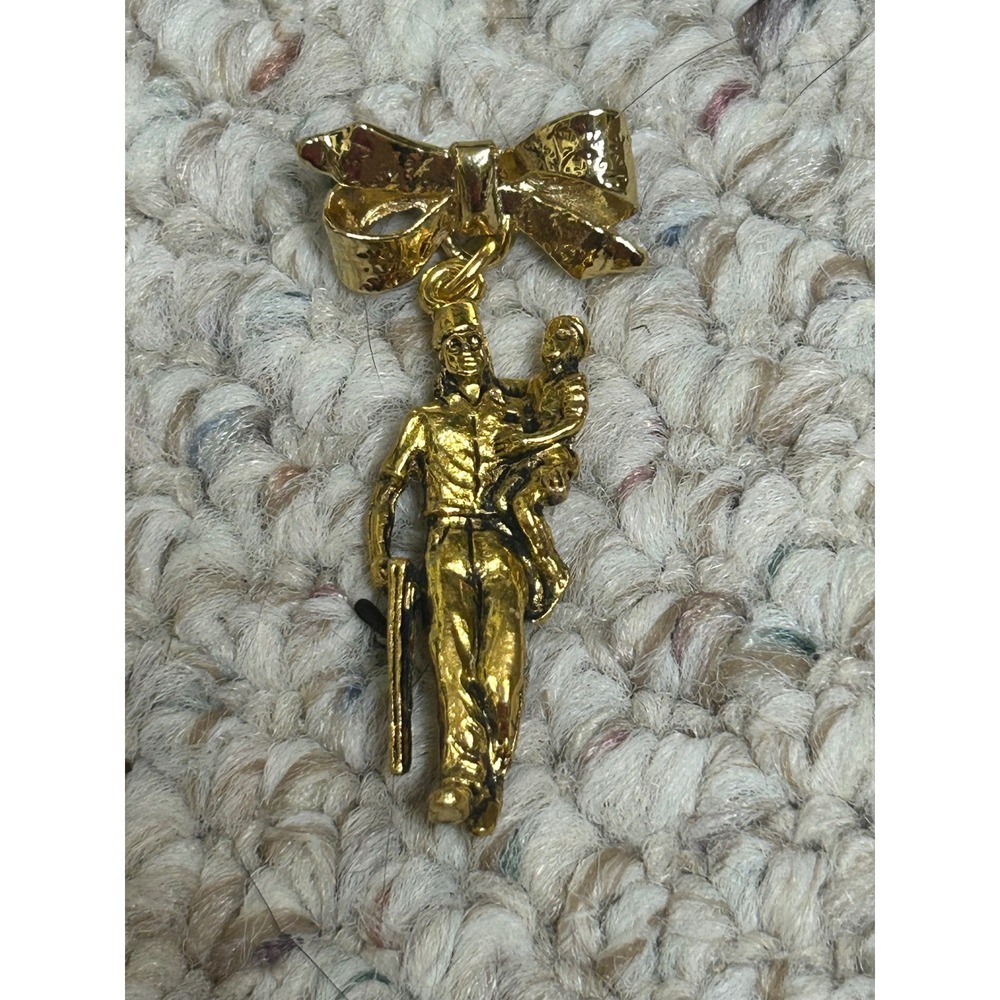 Vintage Gold Tone Soldier Carrying Child Bow Dangle Brooch Pin Commemorative
